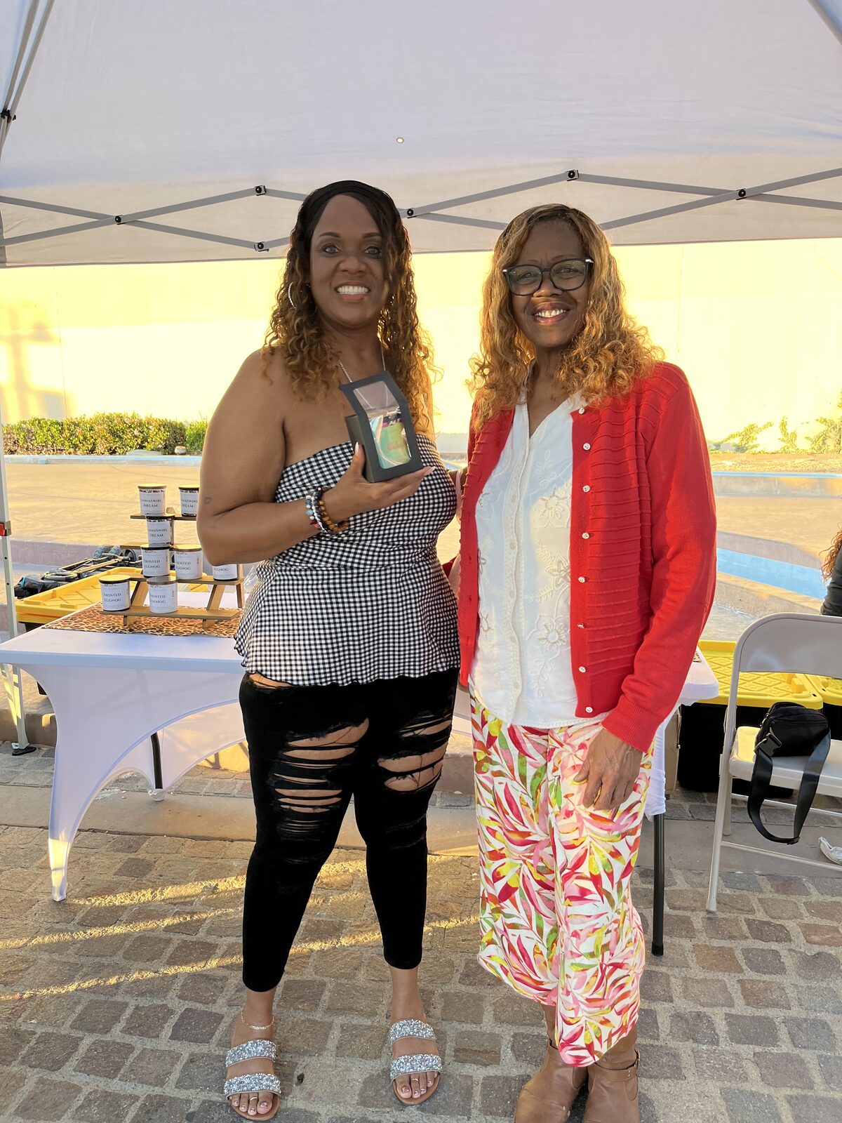 Customer choosing a Debbie's Essentials candle at the booth