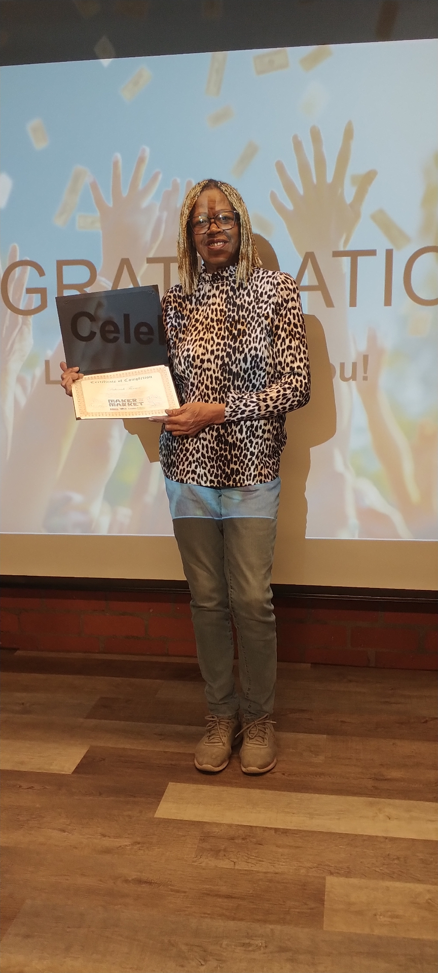 Deborah Turner smiling with her Maker to Market certificate at the celebration