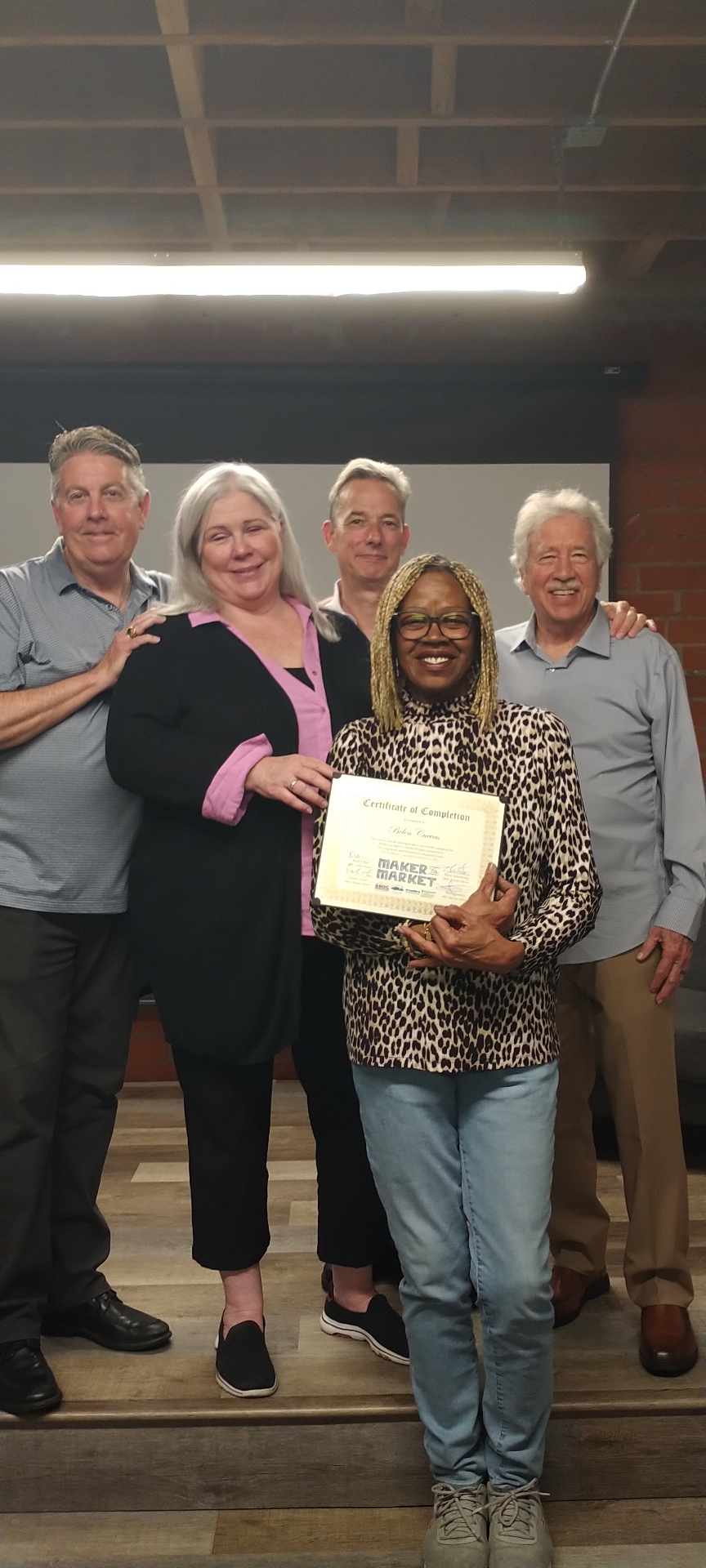 Deborah Turner with the Bellflower Maker to Market team holding her certificate